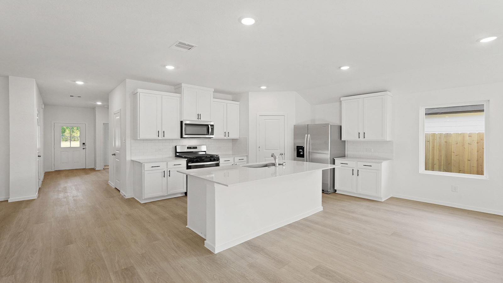Kitchen with an island and vinyl floor