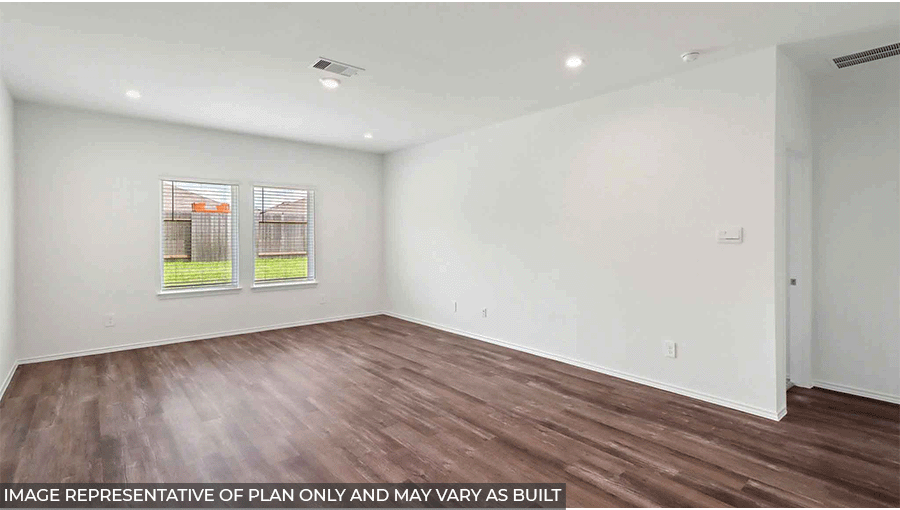 Spacious living area with vinyl flooring