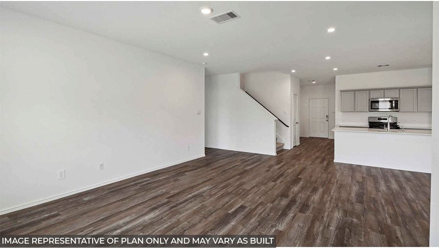 Spacious living area with vinyl flooring