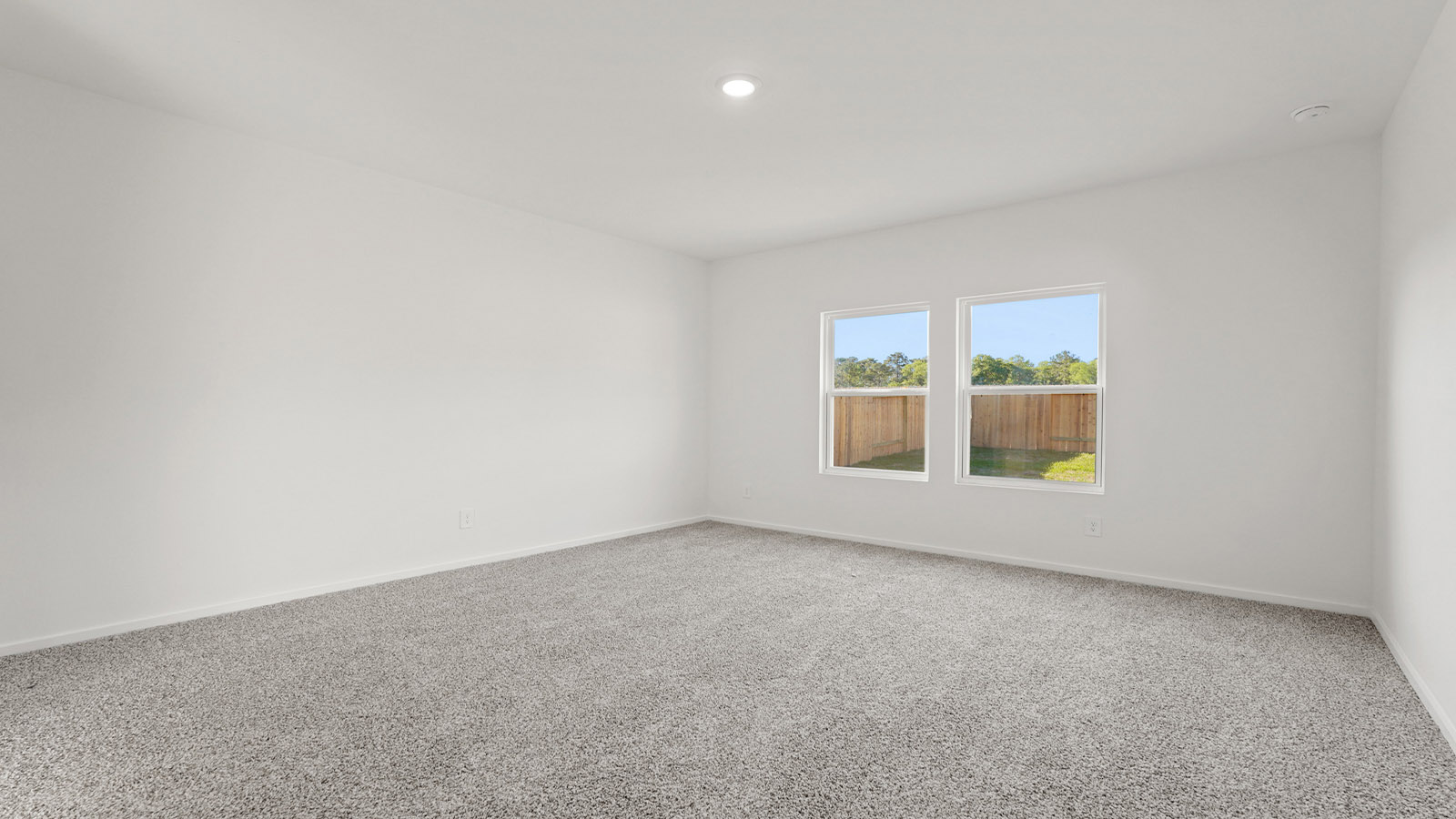 Primary bedroom with carpet flooring