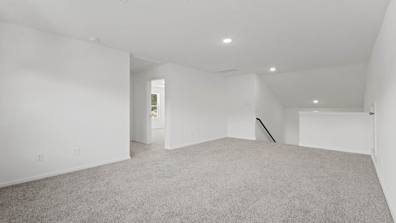 Second story game room with carpet flooring