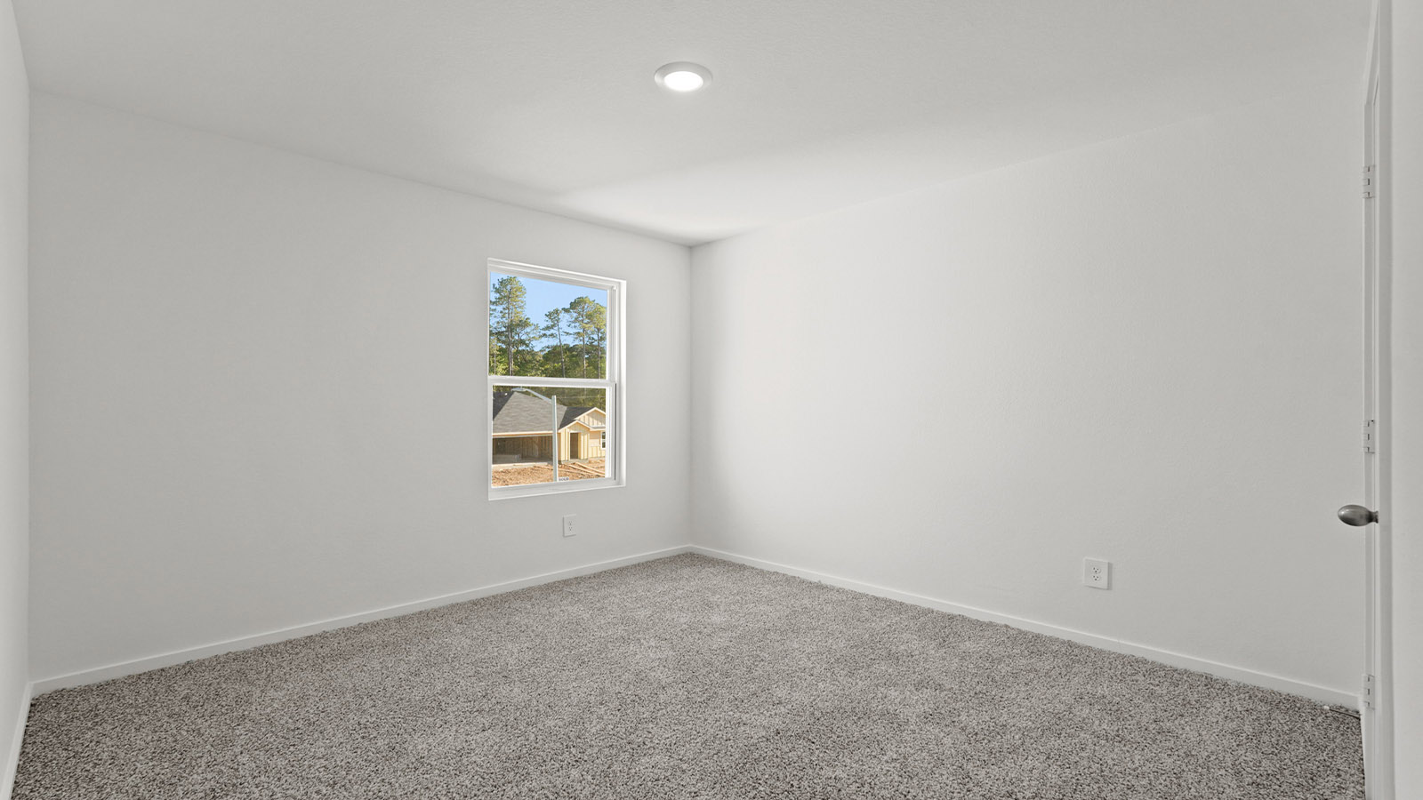 Secondary bedroom with carpet flooring