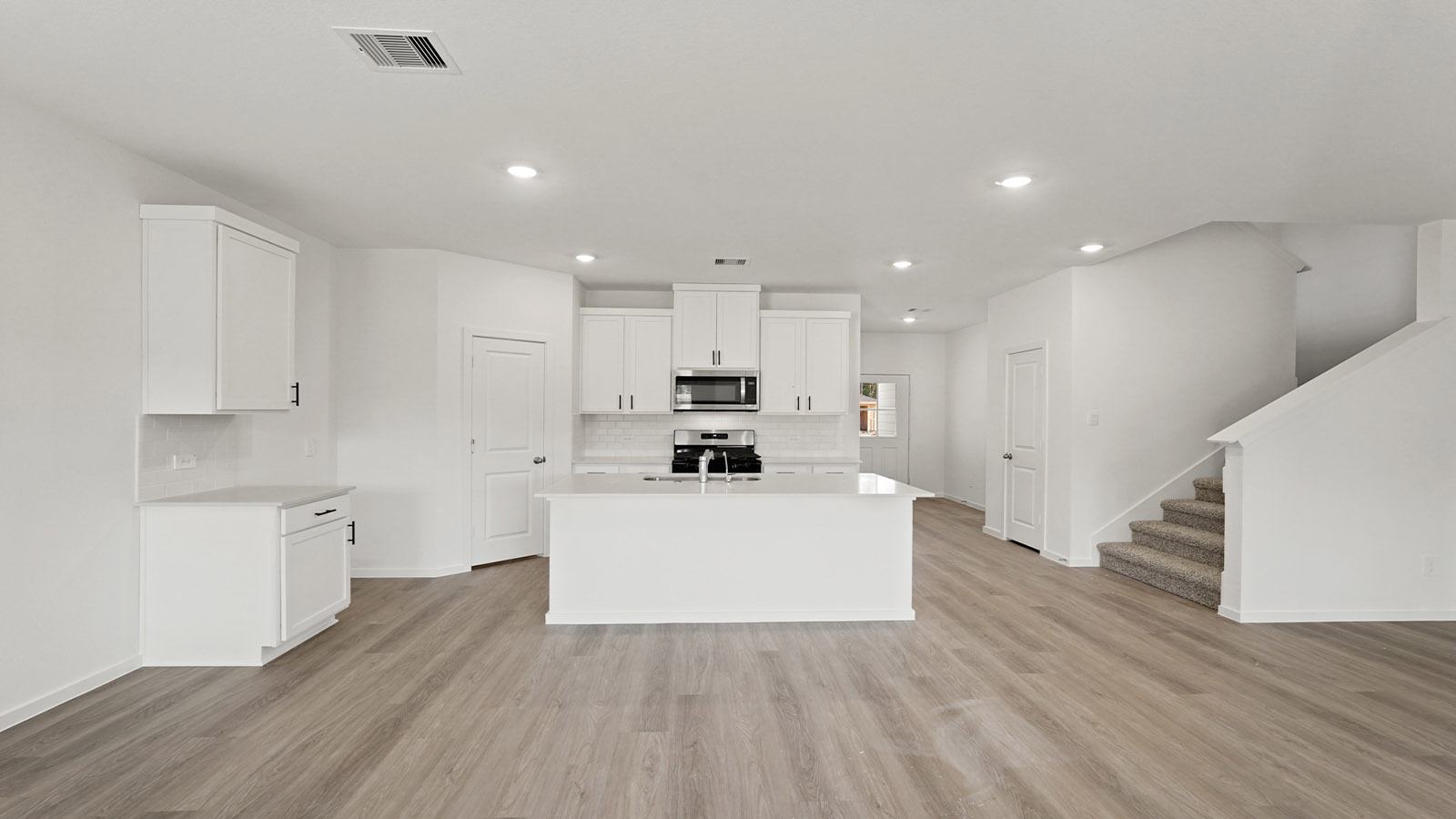Kitchen with an island and vinyl floor