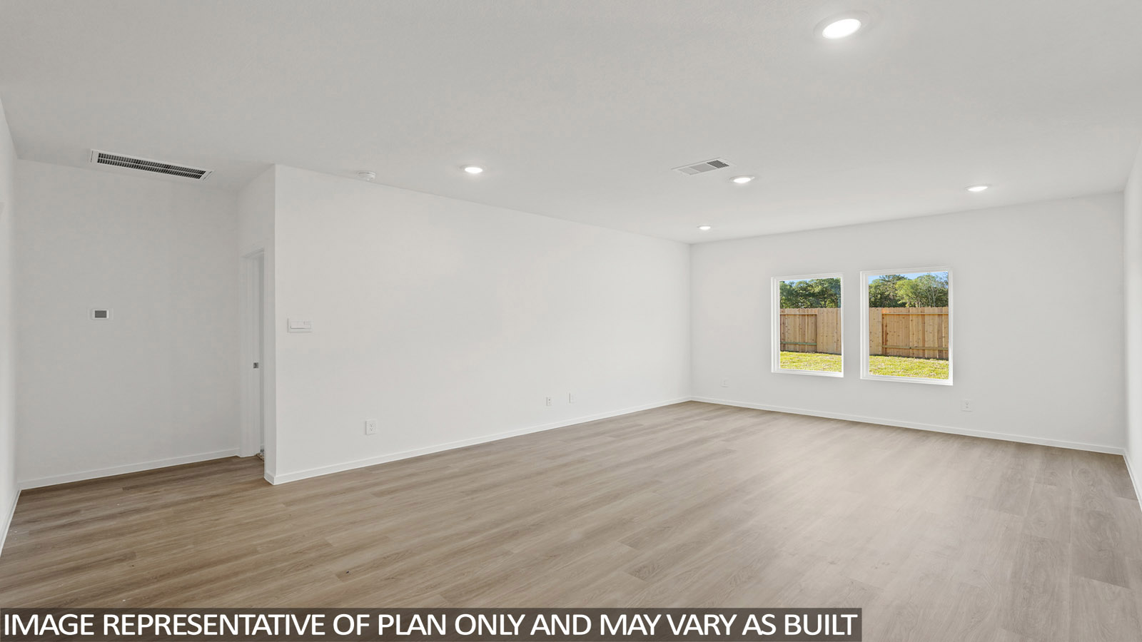 Spacious living area with vinyl flooring and bright windows in New Waverly TX