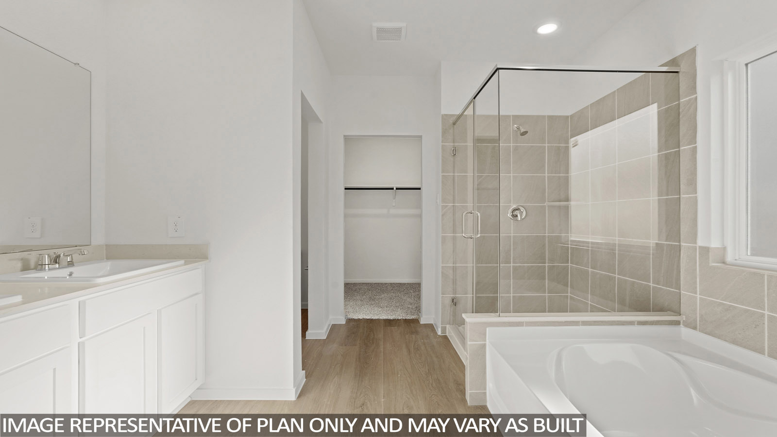 Primary bathroom with soaker tub and tile shower with semi frameless glass in New Waverly TX