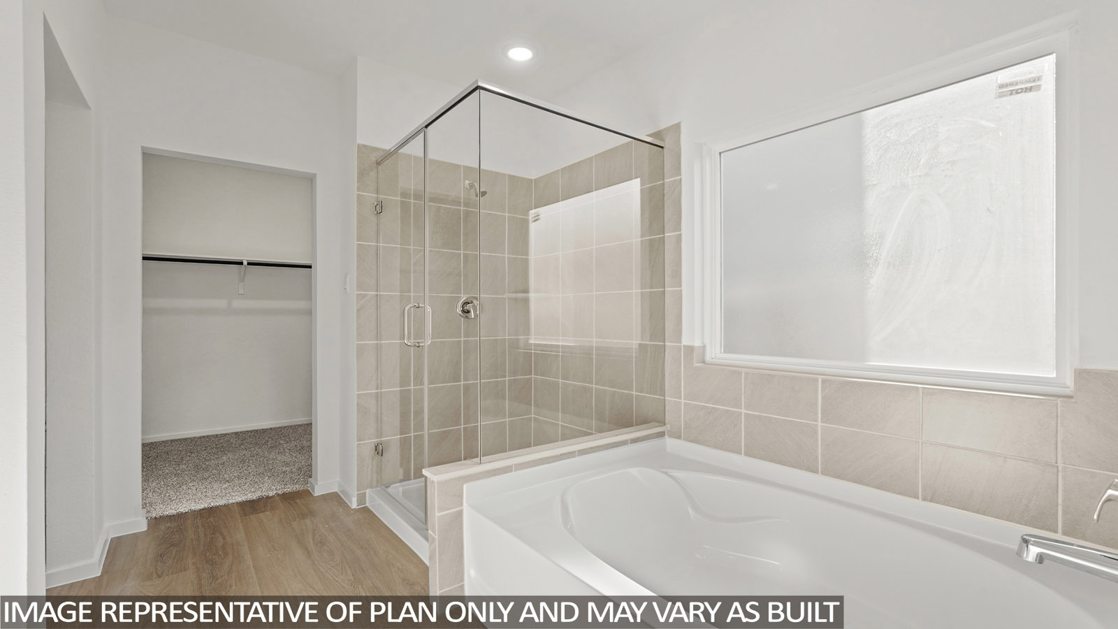 Primary bathroom with soaker tub and tile shower with semi frameless glass in New Waverly TX