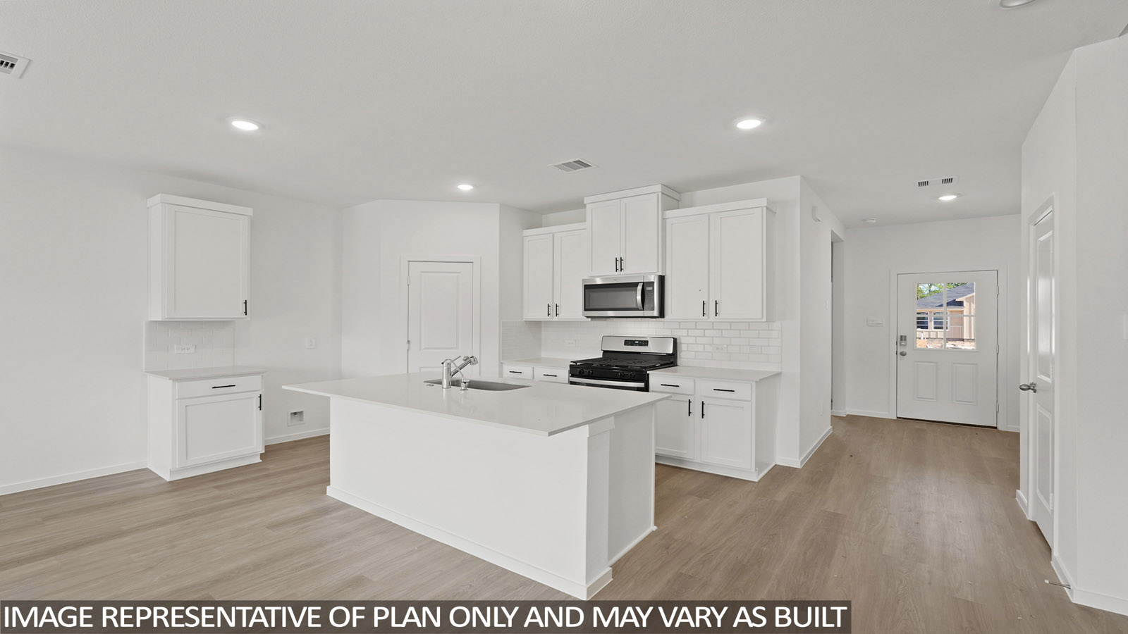 Kitchen with stainless steel appliances, quartz countertops and modern hardware and an island and vinyl floor