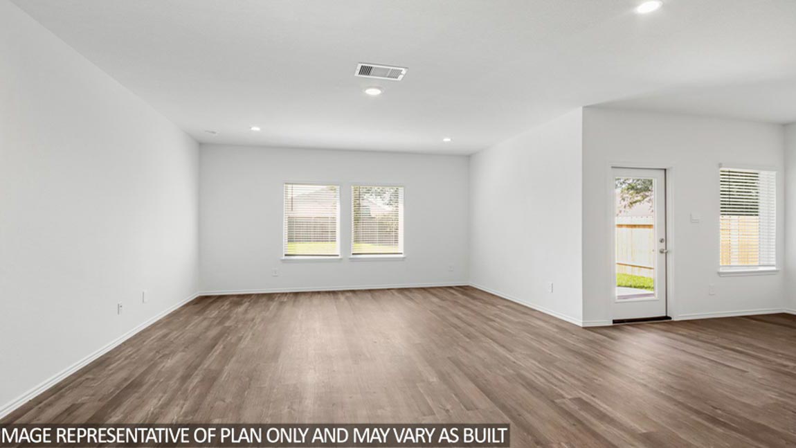 Spacious living area with vinyl flooring