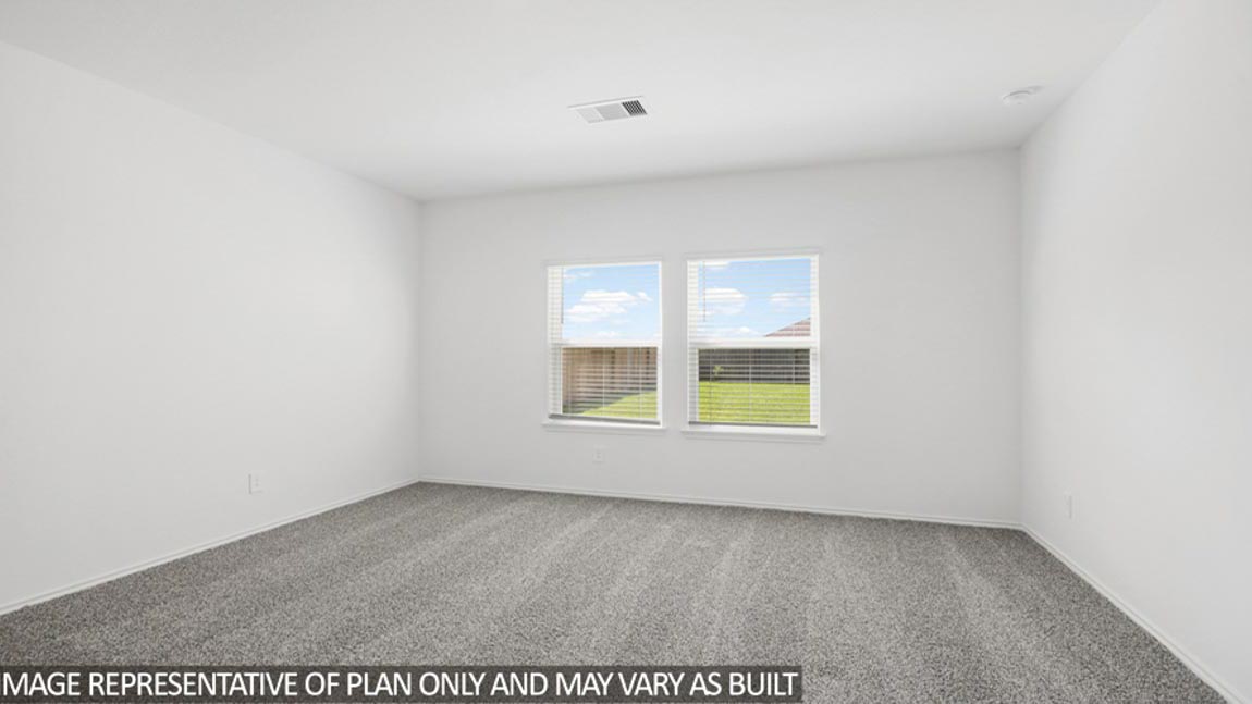 Primary bedroom with carpet flooring