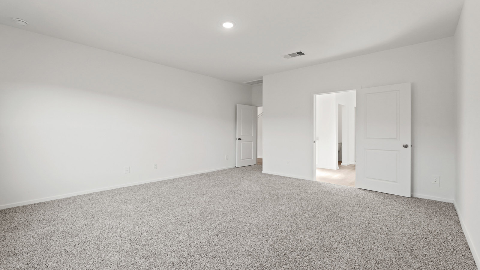 Primary bedroom with carpet flooring
