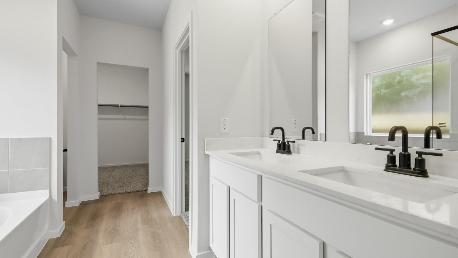 Primary bathroom with soaker tub and tile shower with semi frameless glass in New Waverly TX