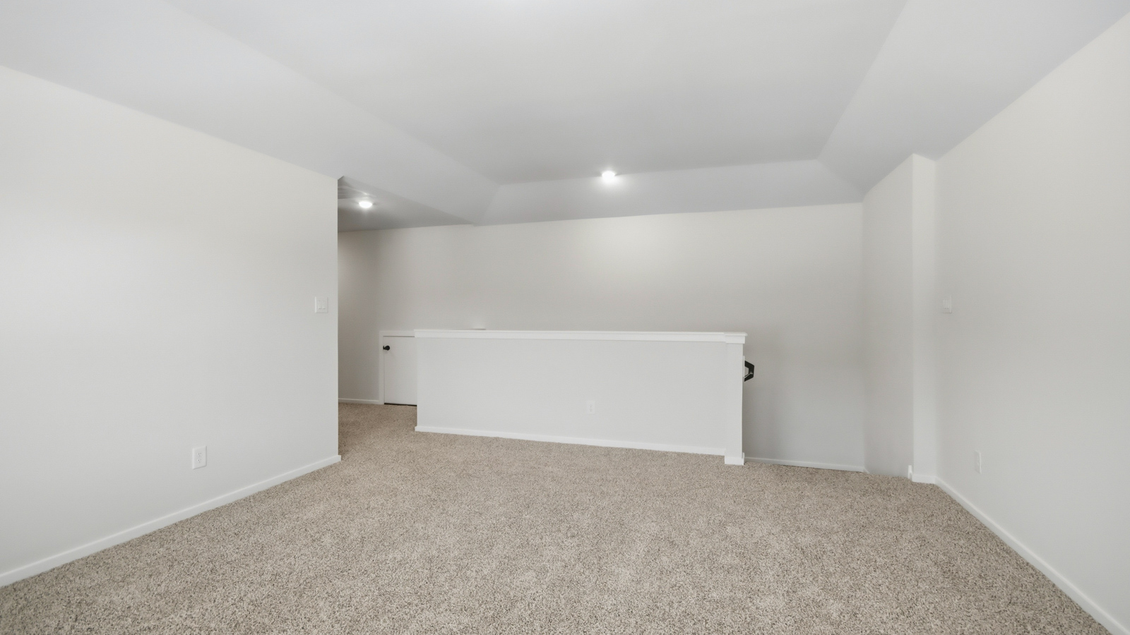 Second story game room with carpet flooring with bright windows in this multi functional space in New Waverly TX