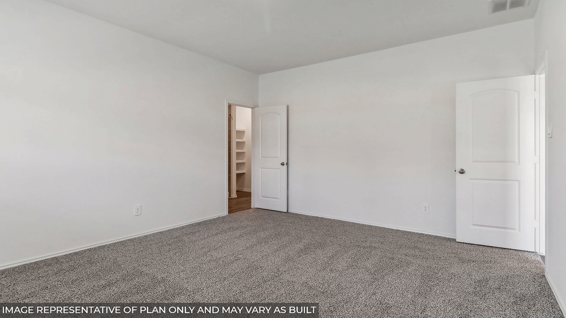 Primary bedroom with carpet flooring