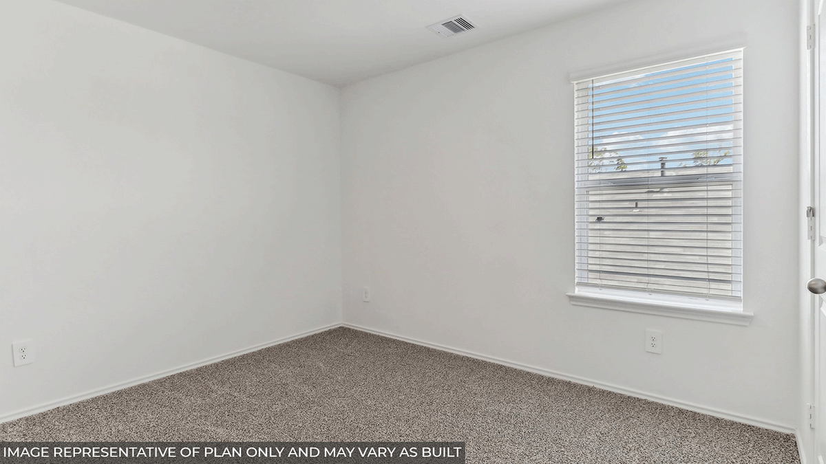 Secondary bedroom with carpet flooring