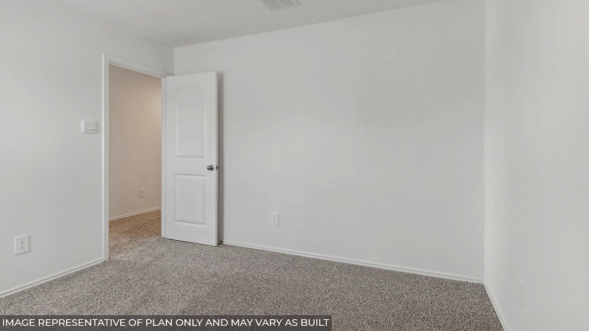 Secondary bedroom with carpet flooring