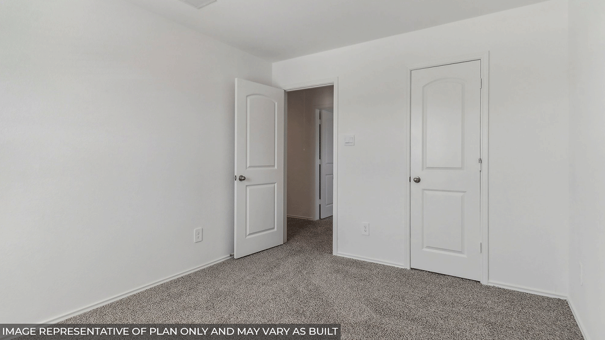 Secondary bedroom with carpet flooring