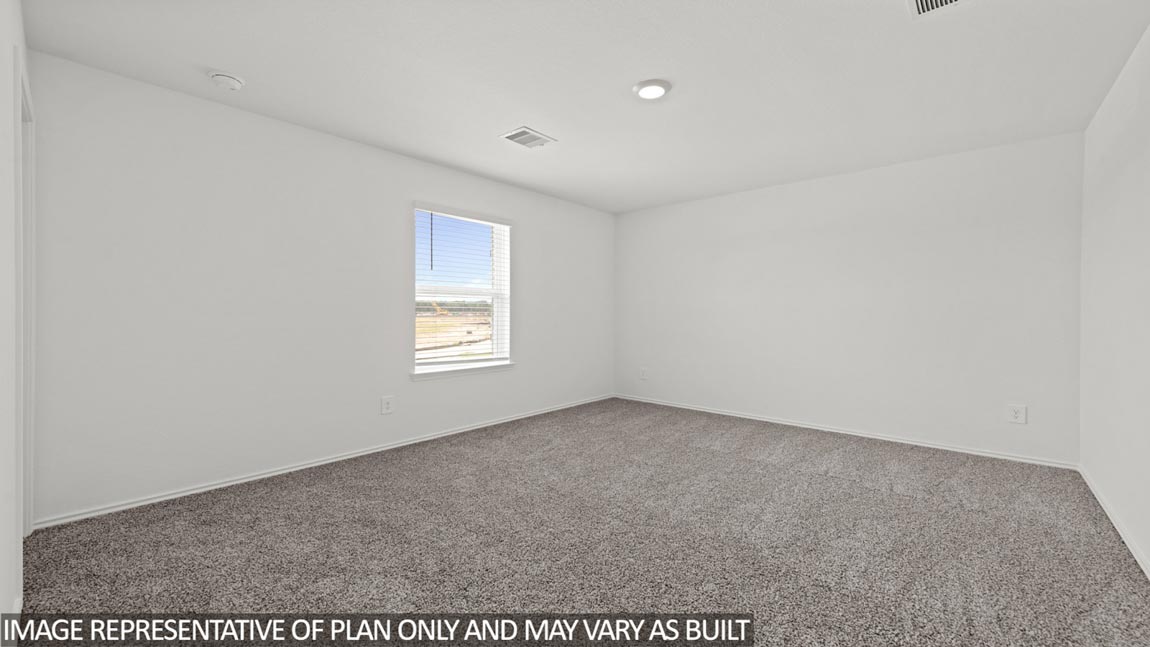 Secondary bedroom with carpet flooring