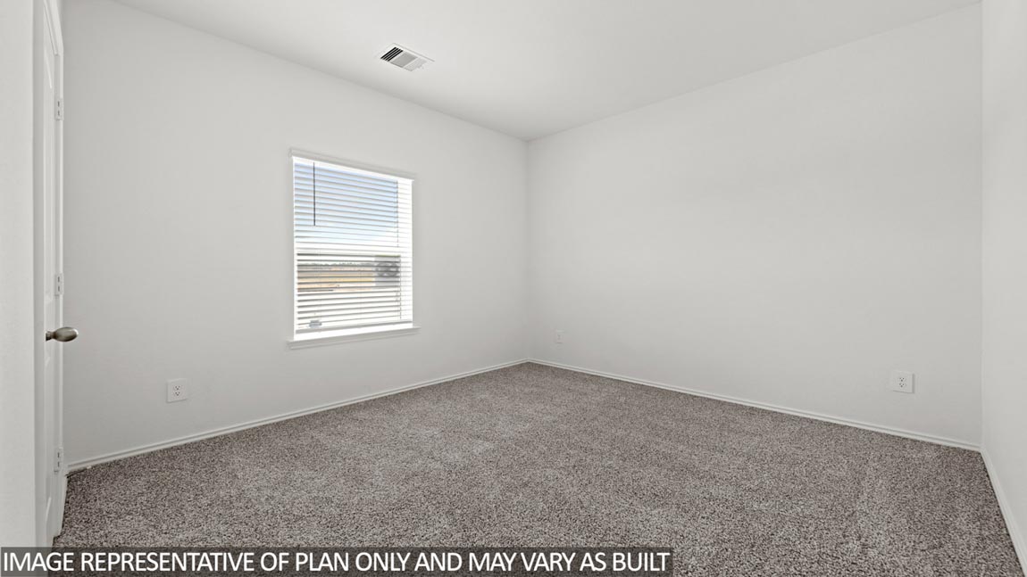 Secondary bedroom with carpet flooring