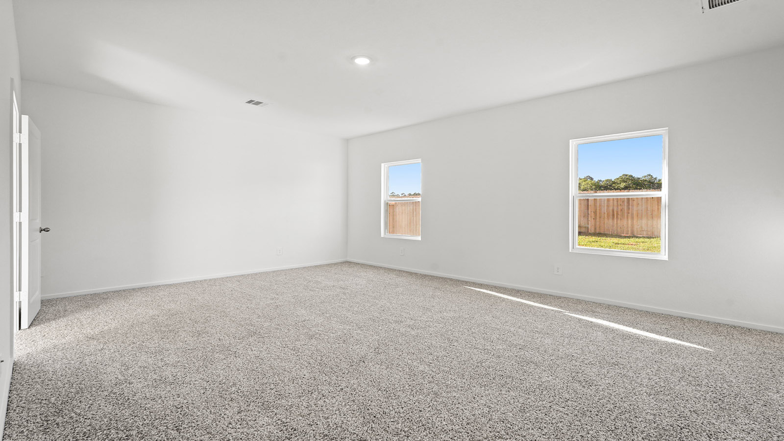 Primary bedroom with carpet flooring