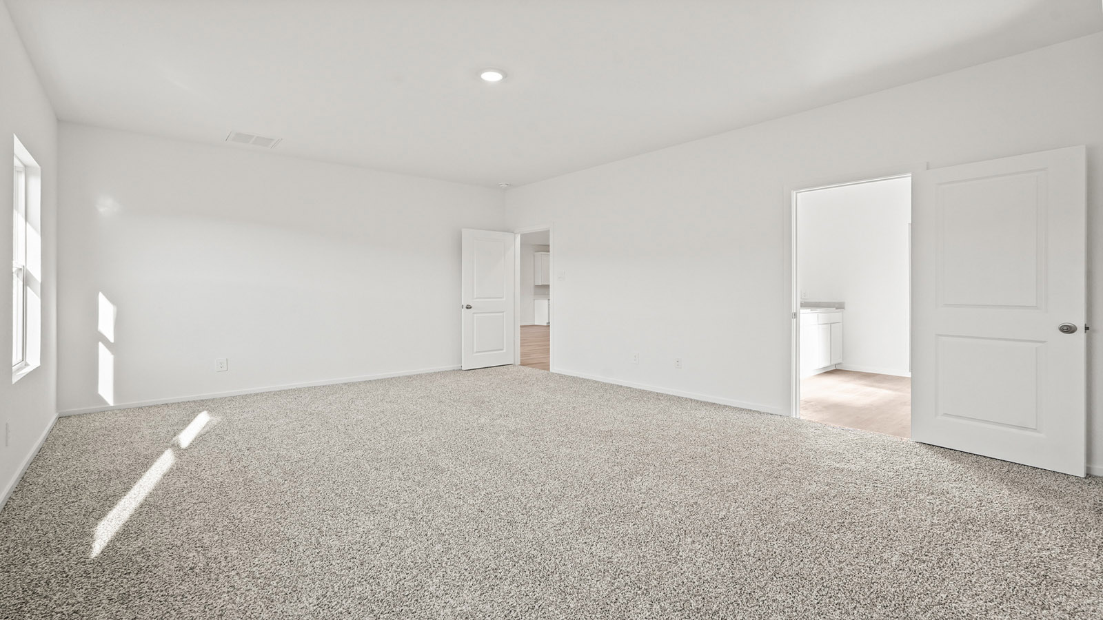 Primary bedroom with carpet flooring