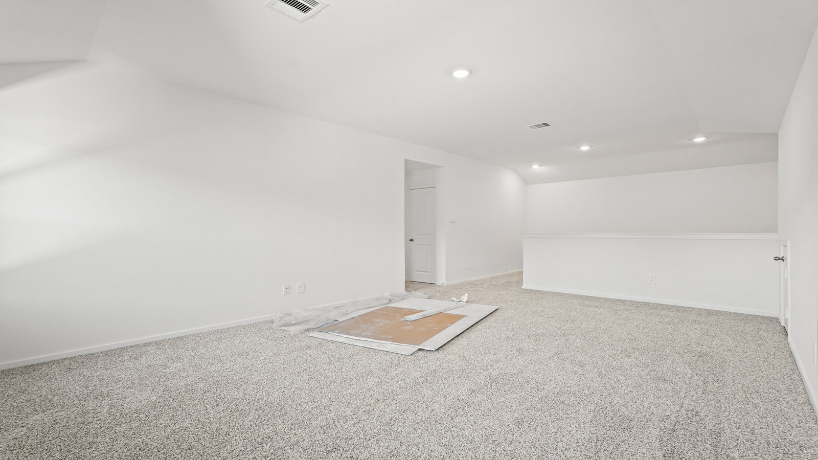 Second story game room with carpet flooring