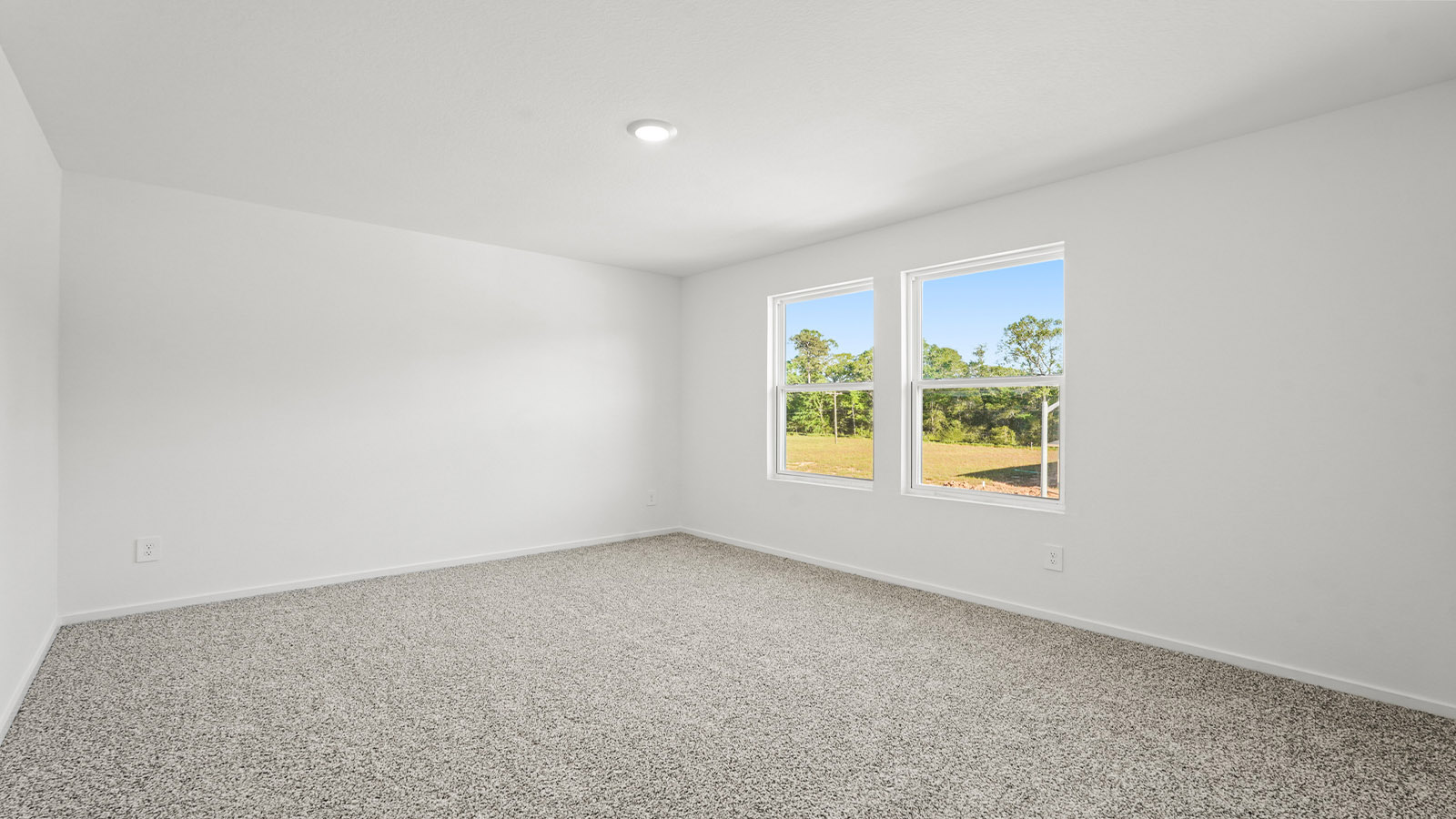 Secondary bedroom with carpet flooring