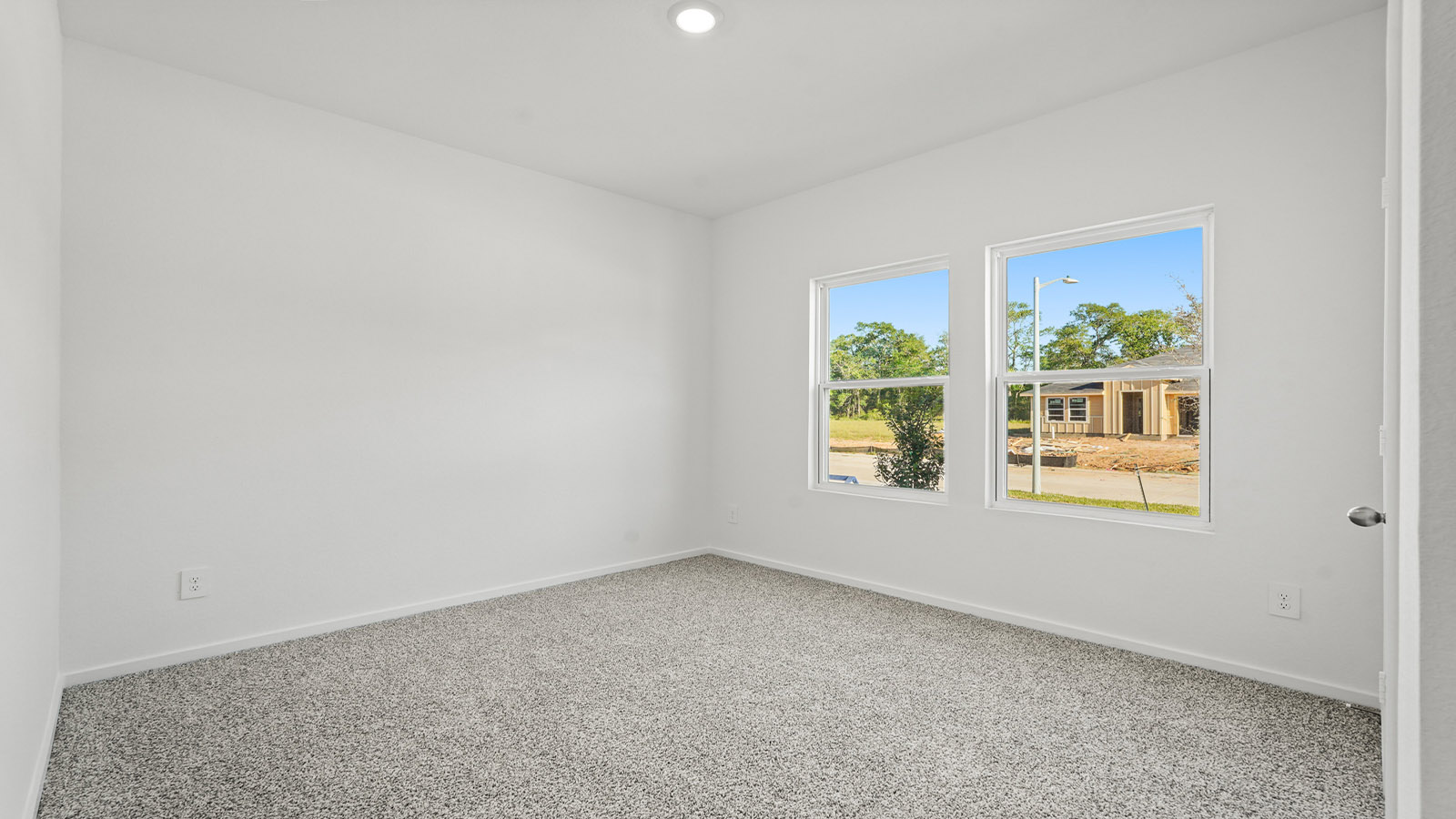 Secondary bedroom with carpet flooring