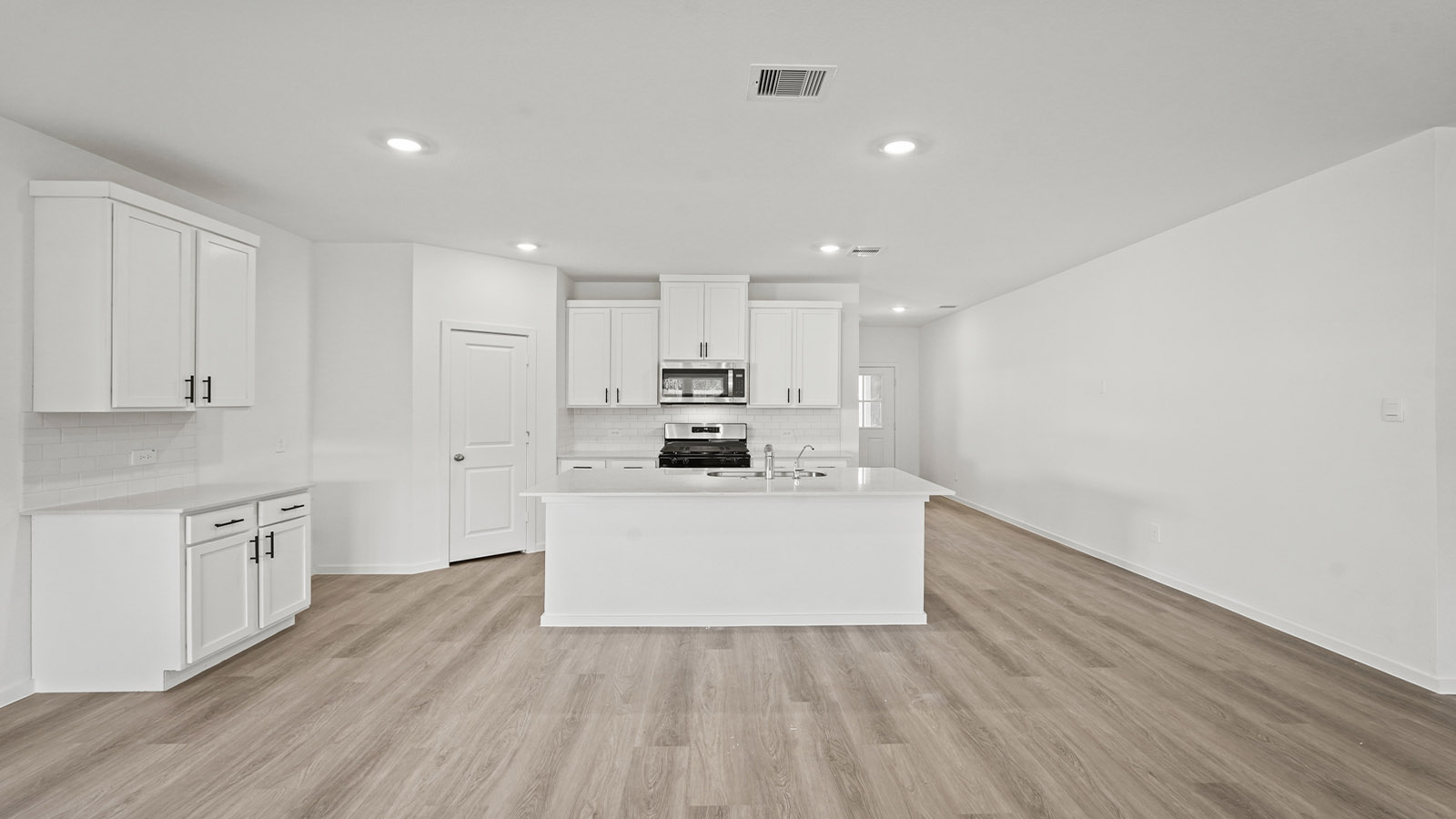 Kitchen with an island and vinyl floor