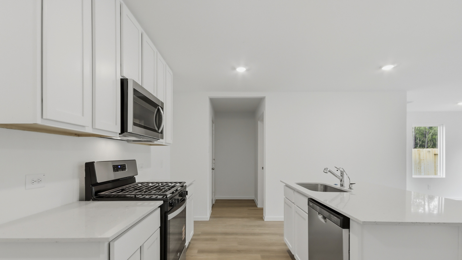 Kitchen with quartz countertops and an island and vinyl floor