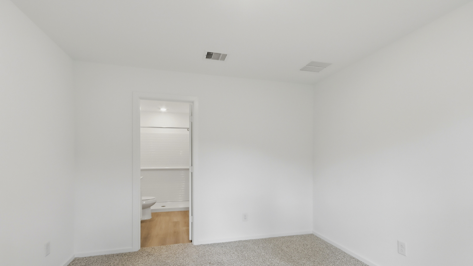 Large Primary bedroom with shag carpet flooring and bright window