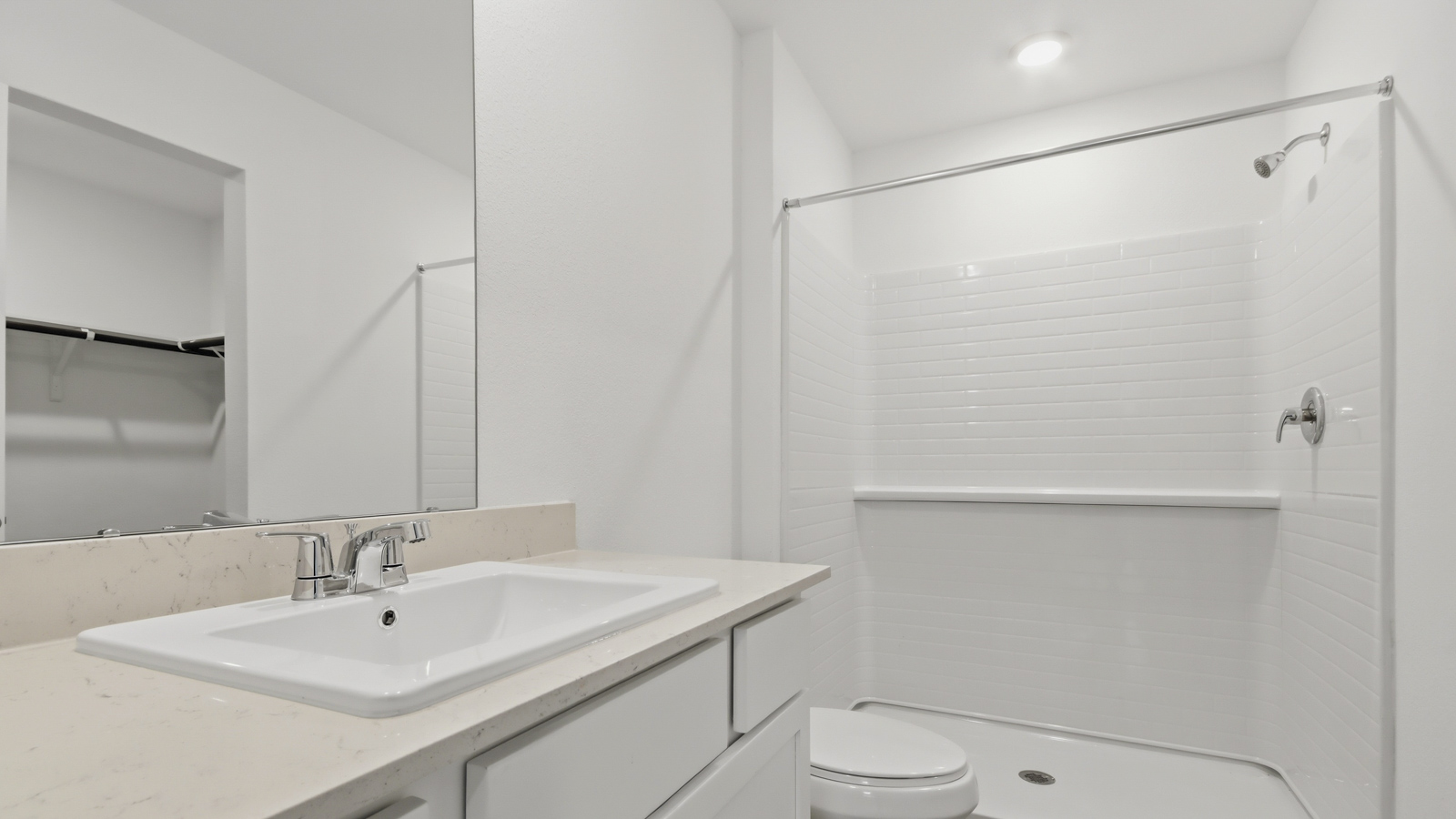 Primary bathroom with stand-alone shower with tiles and semi frameless glass in New Waverly TX