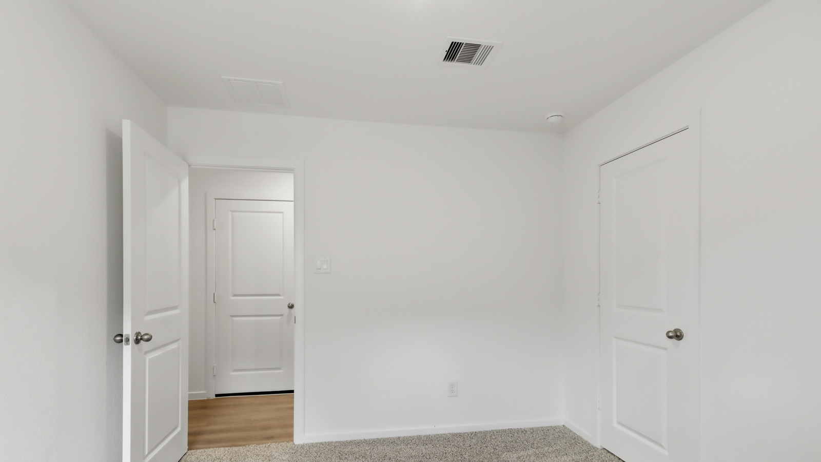 Secondary bedroom with shag carpet flooring and bright window