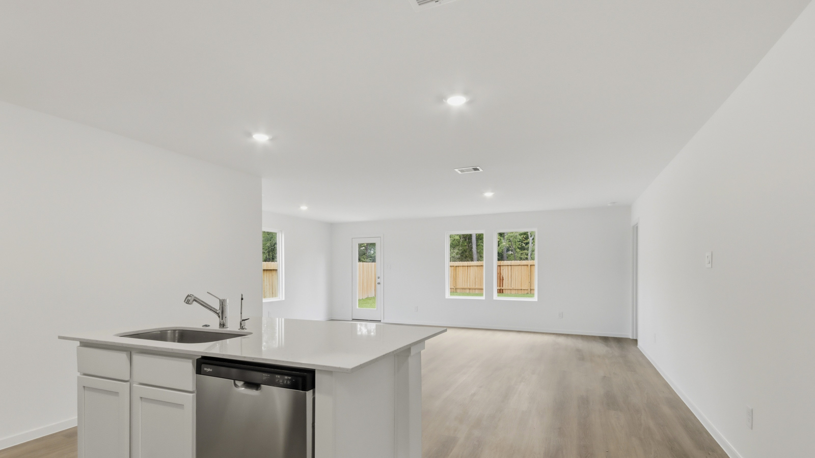 Kitchen with quartz countertops and an island and vinyl floor