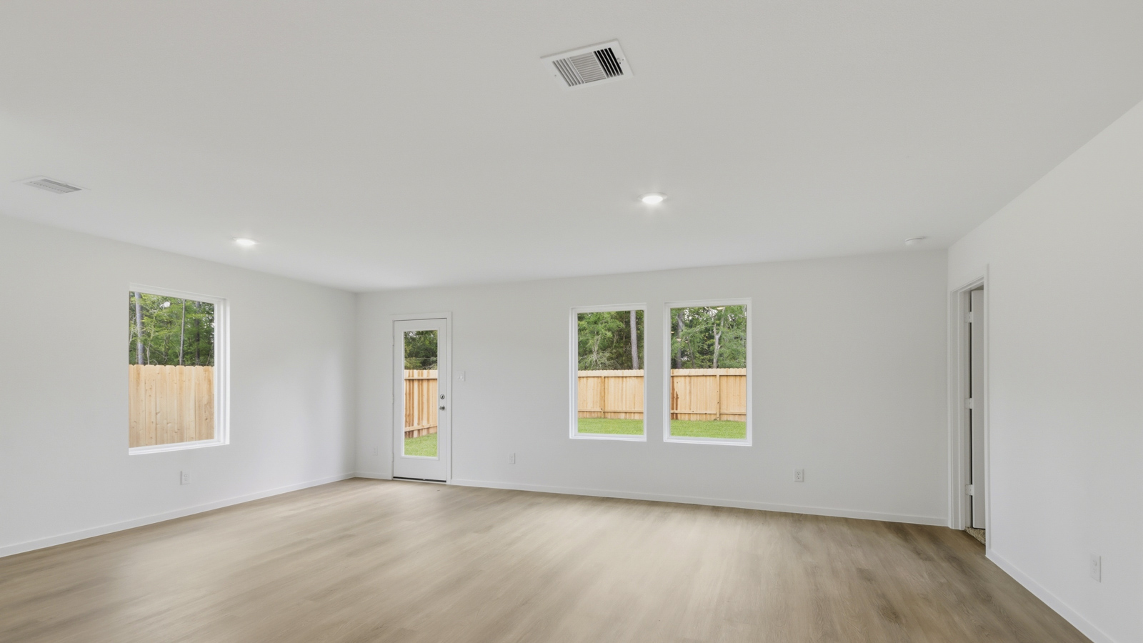 Spacious living area with vinyl flooring and bright windows in Katy TX