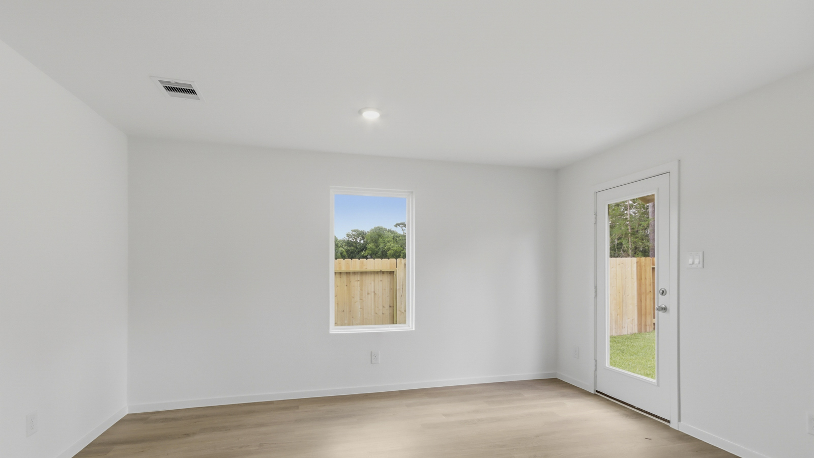 Spacious living area with vinyl flooring and bright windows in Katy TX