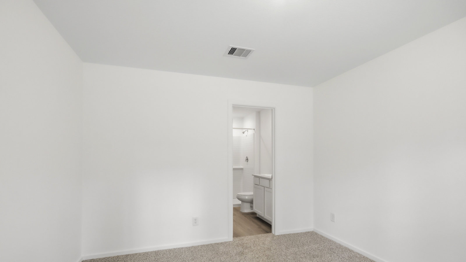 Large Primary bedroom with shag carpet flooring and bright window