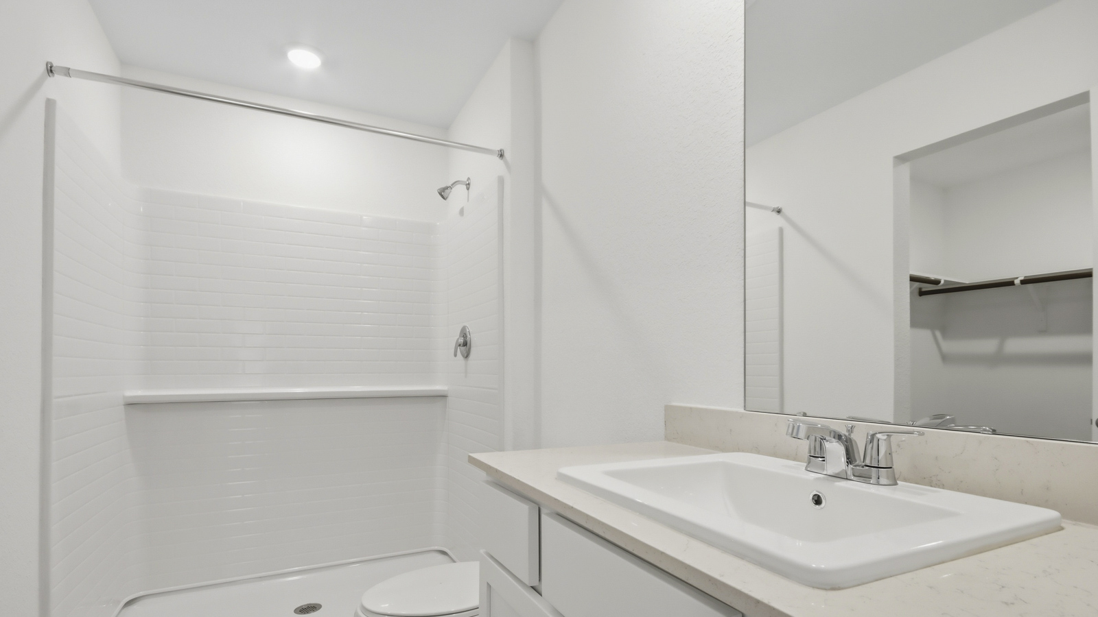 Primary bathroom with stand-alone shower with tiles and semi frameless glass in New Waverly TX