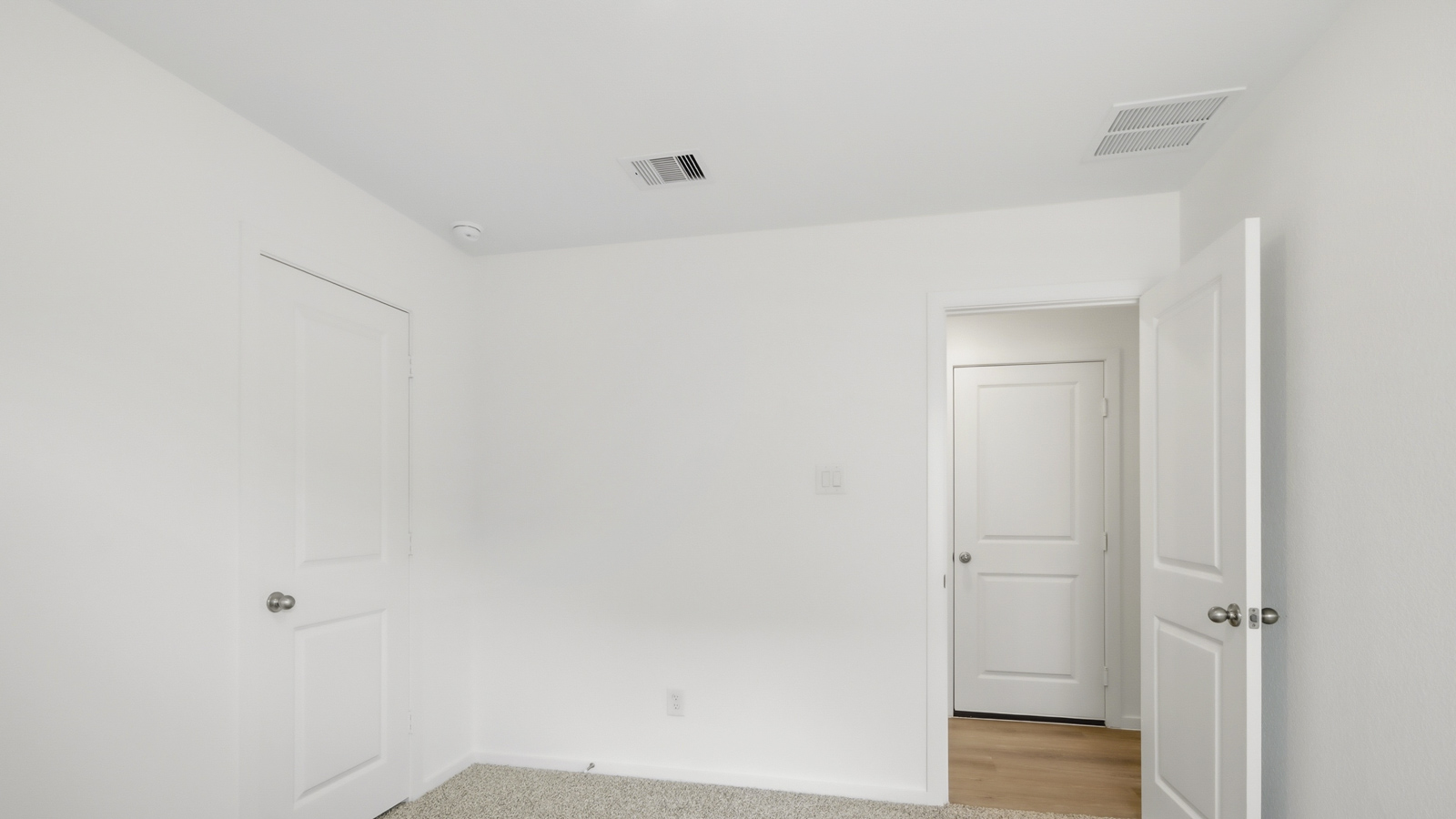 Secondary bedroom with shag carpet flooring and bright window