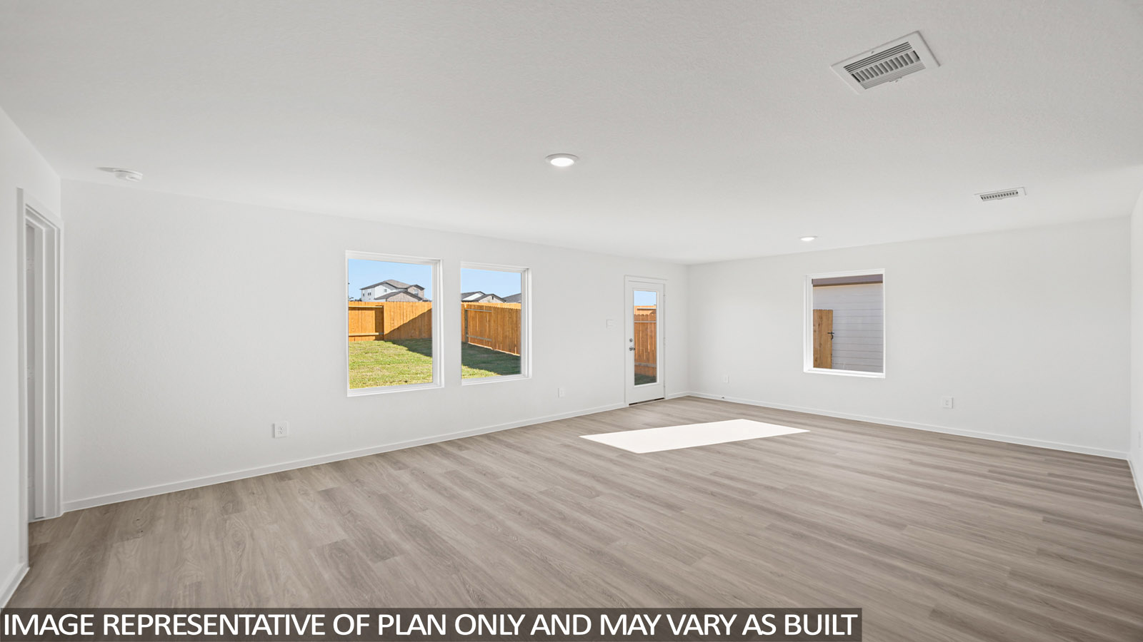 Spacious living area with vinyl flooring