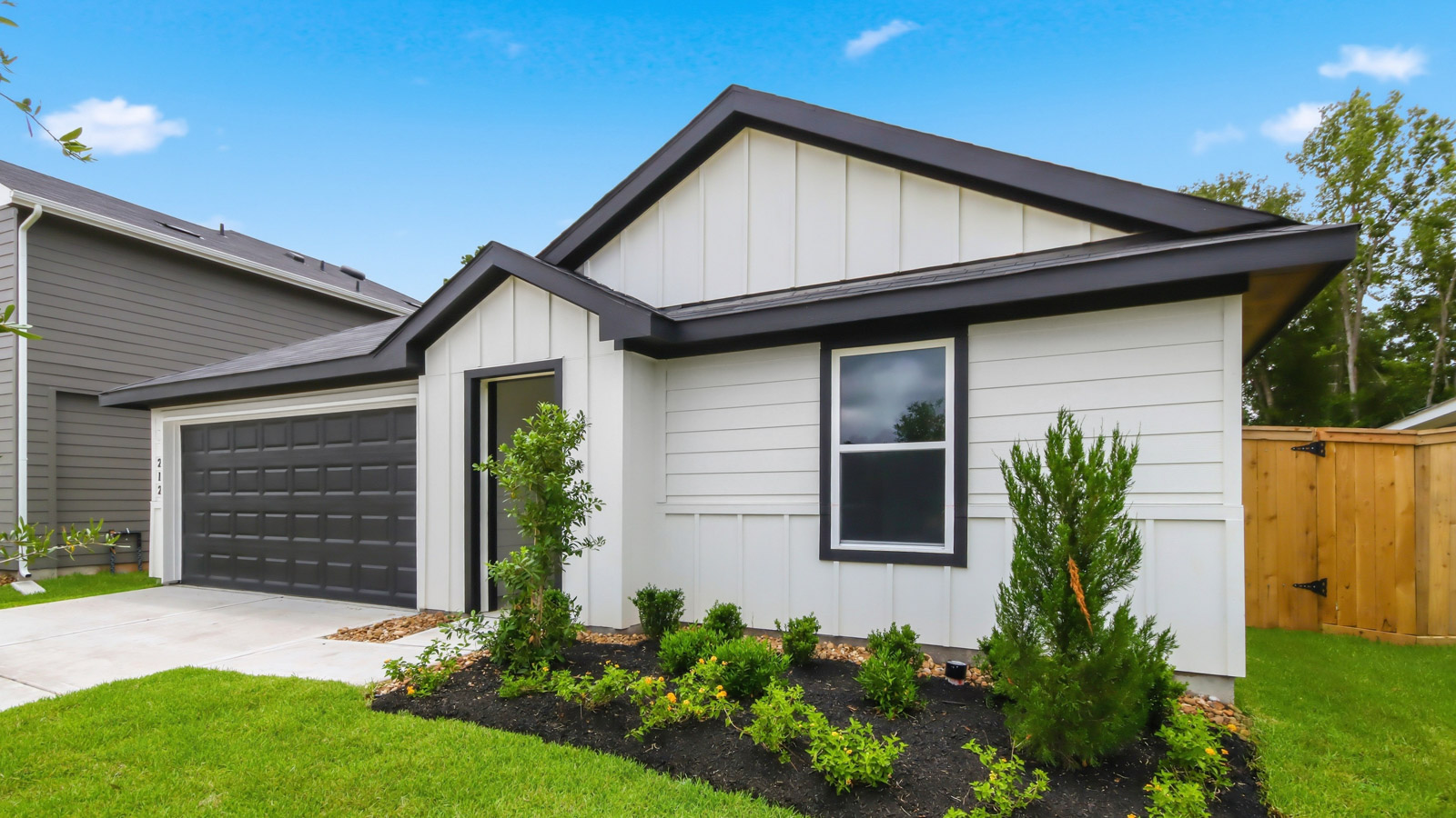 One story home with two car garage with brick and siding in New Waverly TX