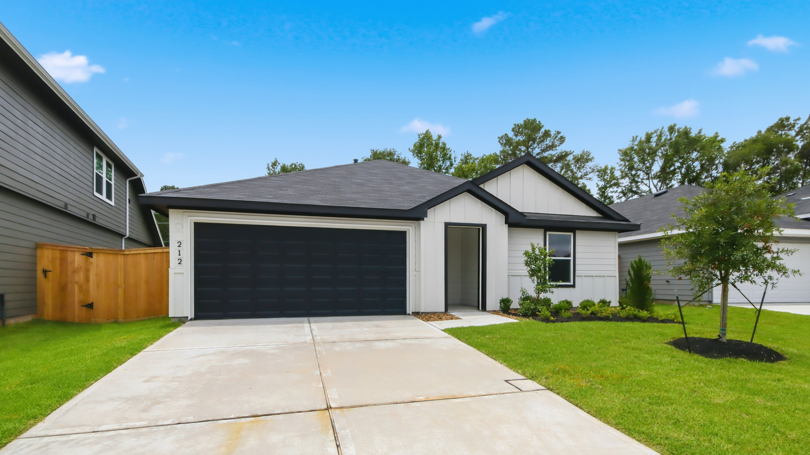 One story home with two car garage with brick and siding in New Waverly TX