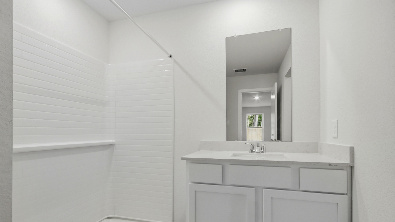 Primary bathroom with stand-alone shower with tiles and semi frameless glass in New Waverly TX