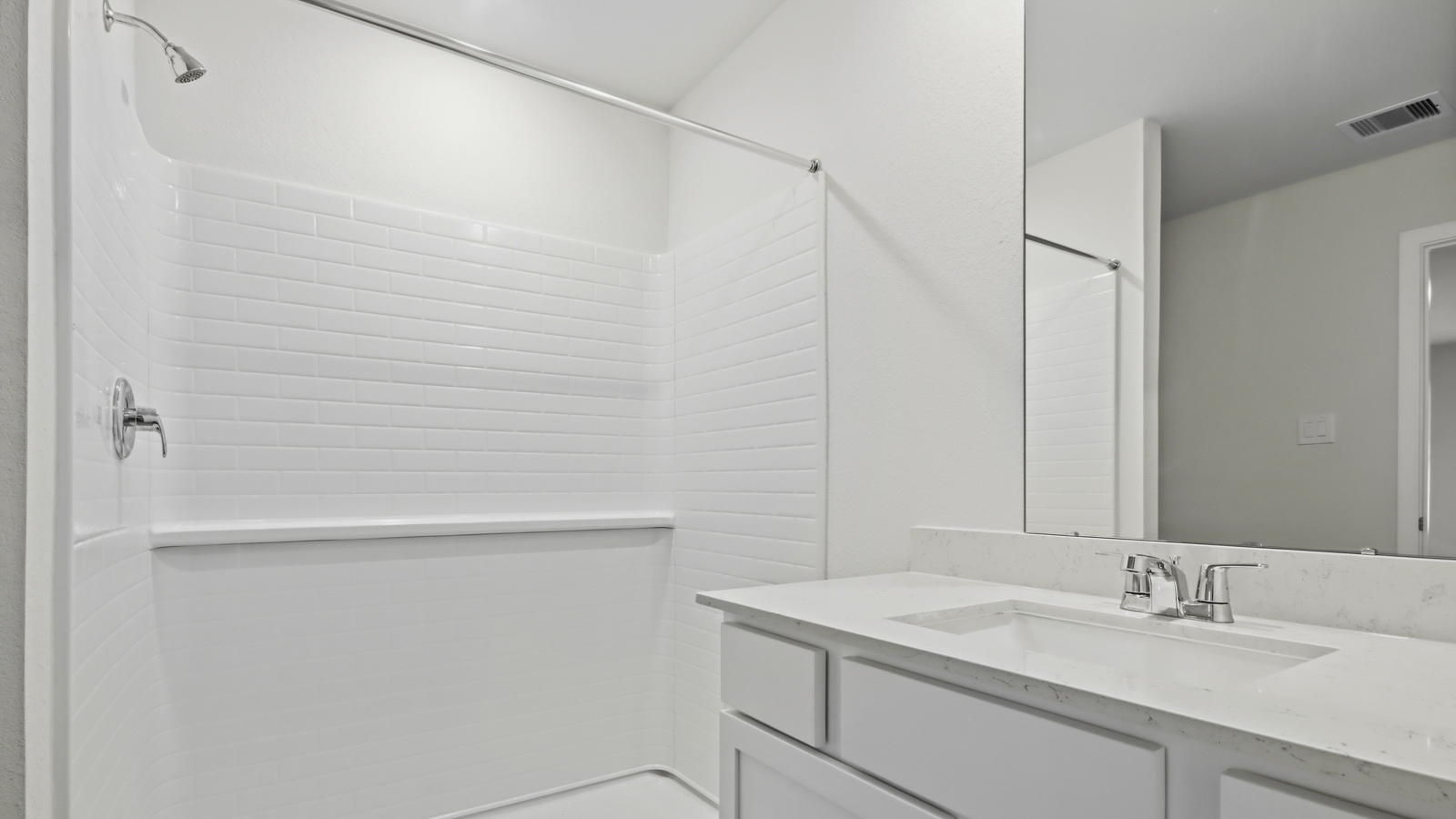 Primary bathroom with stand-alone shower with tiles and semi frameless glass in New Waverly TX