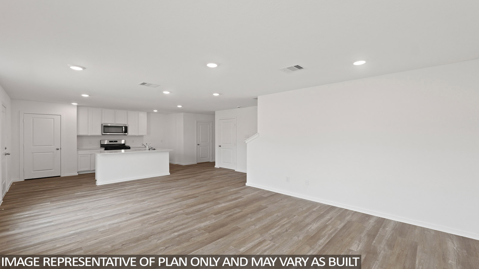 Kitchen with quartz countertops and modern hardware and an island and vinyl floor