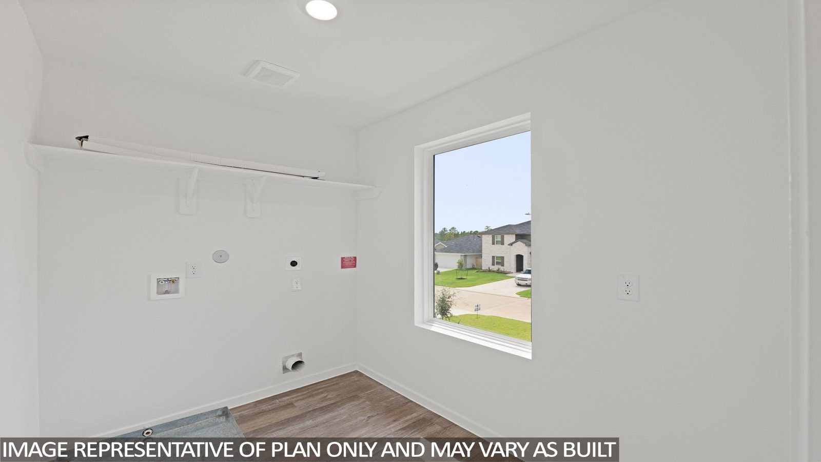 Utility room with storage located off the entry hallway and garage door
