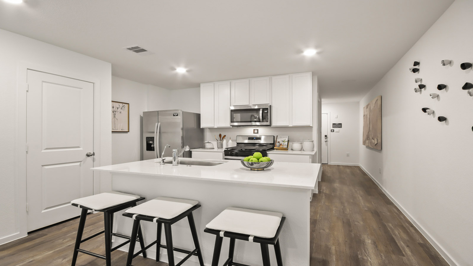Kitchen with quartz countertops and modern hardware and an island and vinyl floor
