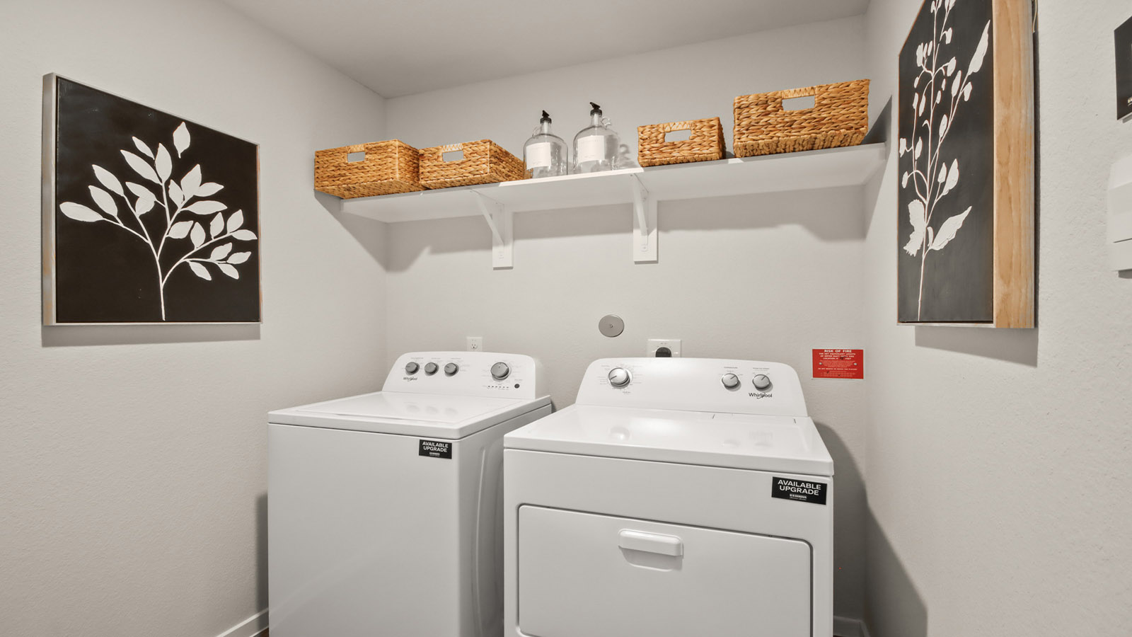 Utility room with storage located off the entry hallway and garage door