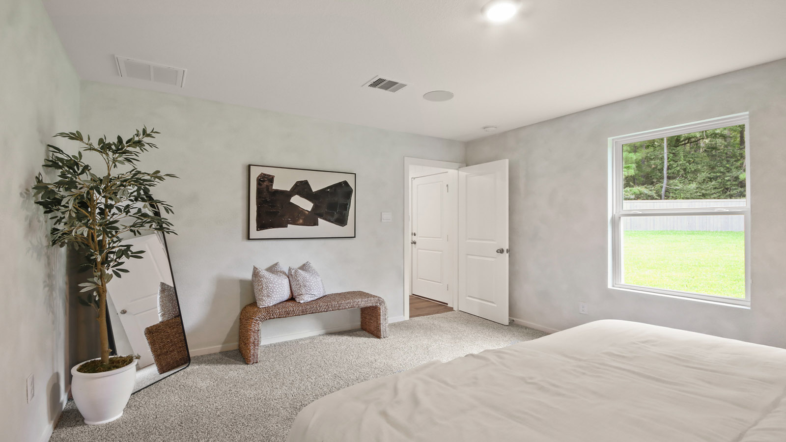 Large Primary bedroom with shag carpet flooring and bright window