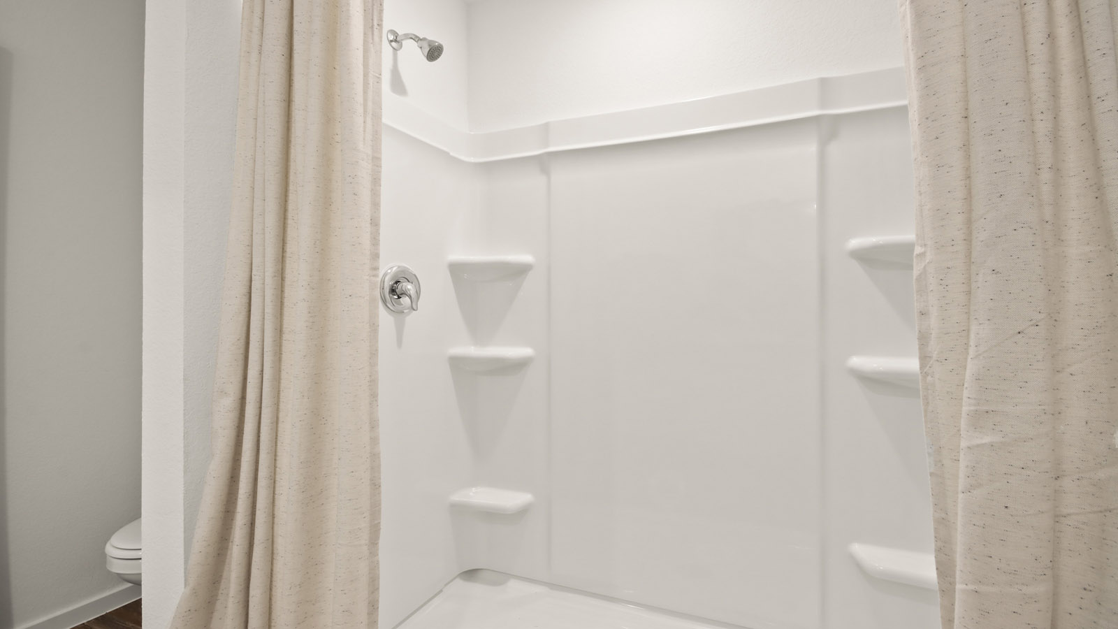 Primary bathroom with stand-alone shower with tiles and semi frameless glass in Willis TX