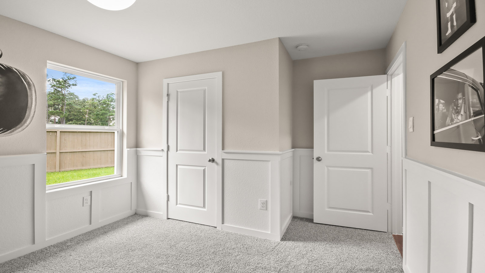 Secondary bedroom with shag carpet flooring and bright window